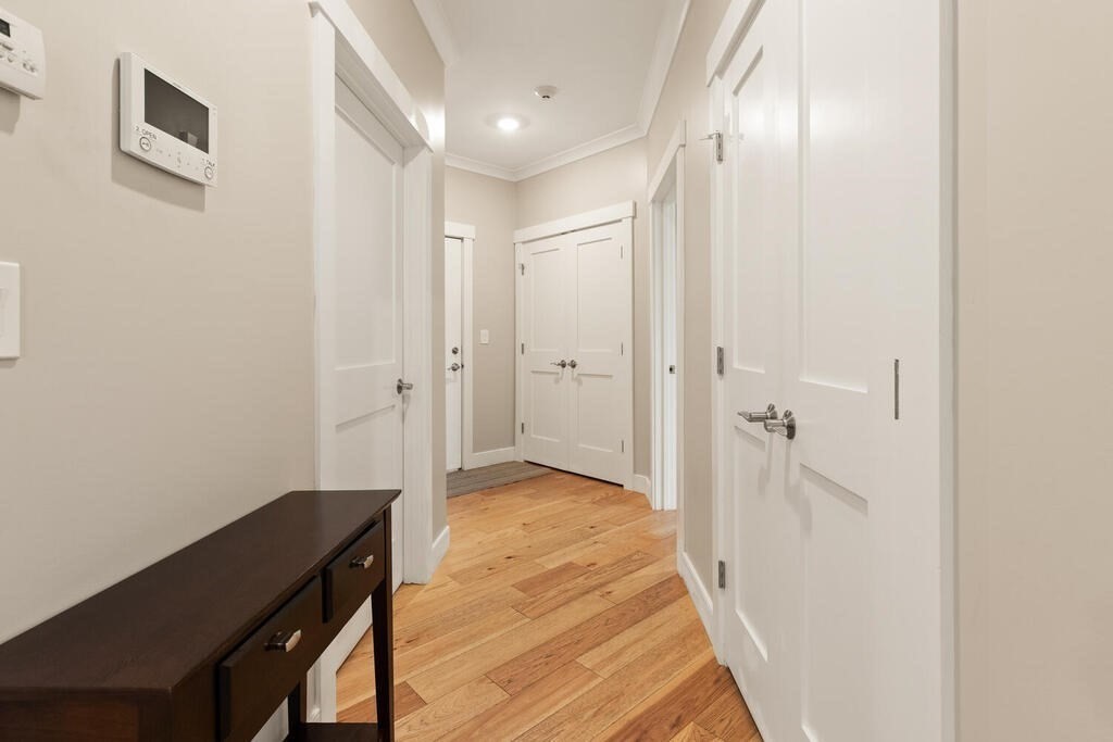 11 Executive Drive, Unit 118 Stoneham, MA 02180 - Photo 20 of 36 a view of a hallway with wooden floor