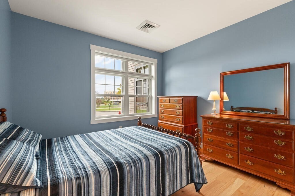 11 Executive Drive, Unit 118 Stoneham, MA 02180 - Photo 23 of 36 a bedroom with a bed and flat screen tv