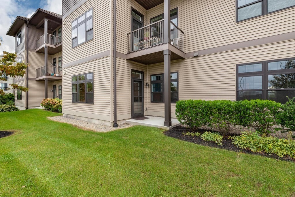 11 Executive Drive, Unit 118 Stoneham, MA 02180 - Photo 26 of 36 a view of a house with a yard and plants