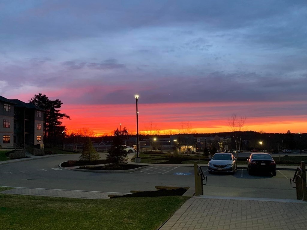 11 Executive Drive, Unit 118 Stoneham, MA 02180 - Photo 28 of 36 a view of car parked on road with building
