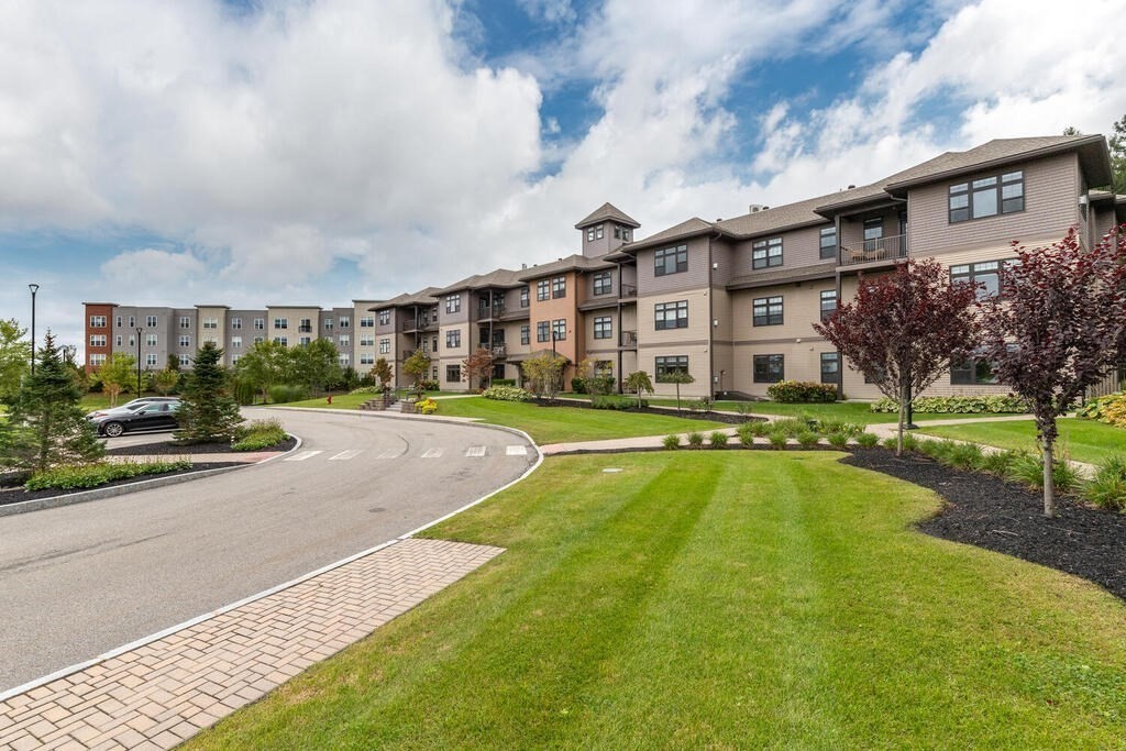 11 Executive Drive, Unit 118 Stoneham, MA 02180 - Photo 33 of 36 a view of a house with a swimming pool and a yard