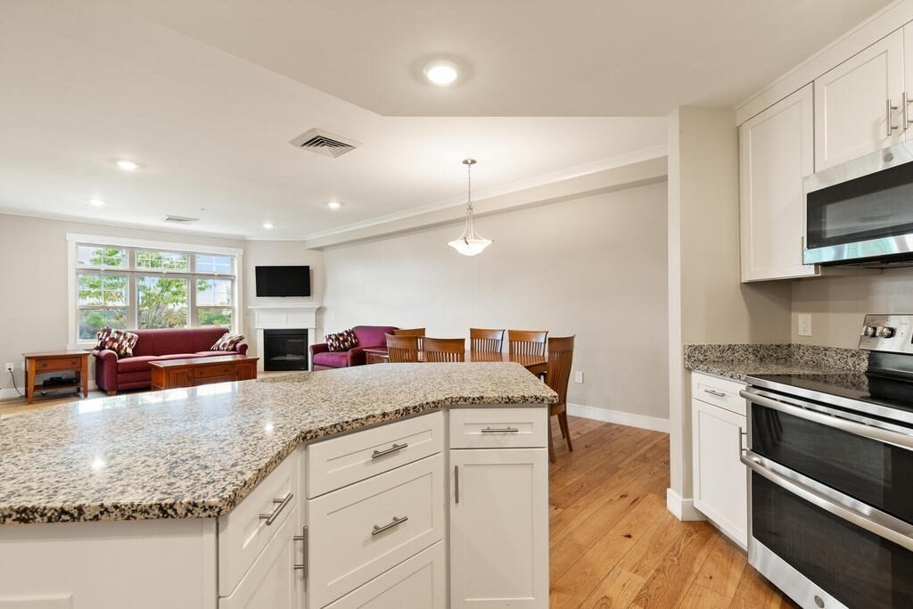 11 Executive Drive, Unit 118 Stoneham, MA 02180 - Photo 4 of 36 a kitchen with granite countertop a stove and cabinets