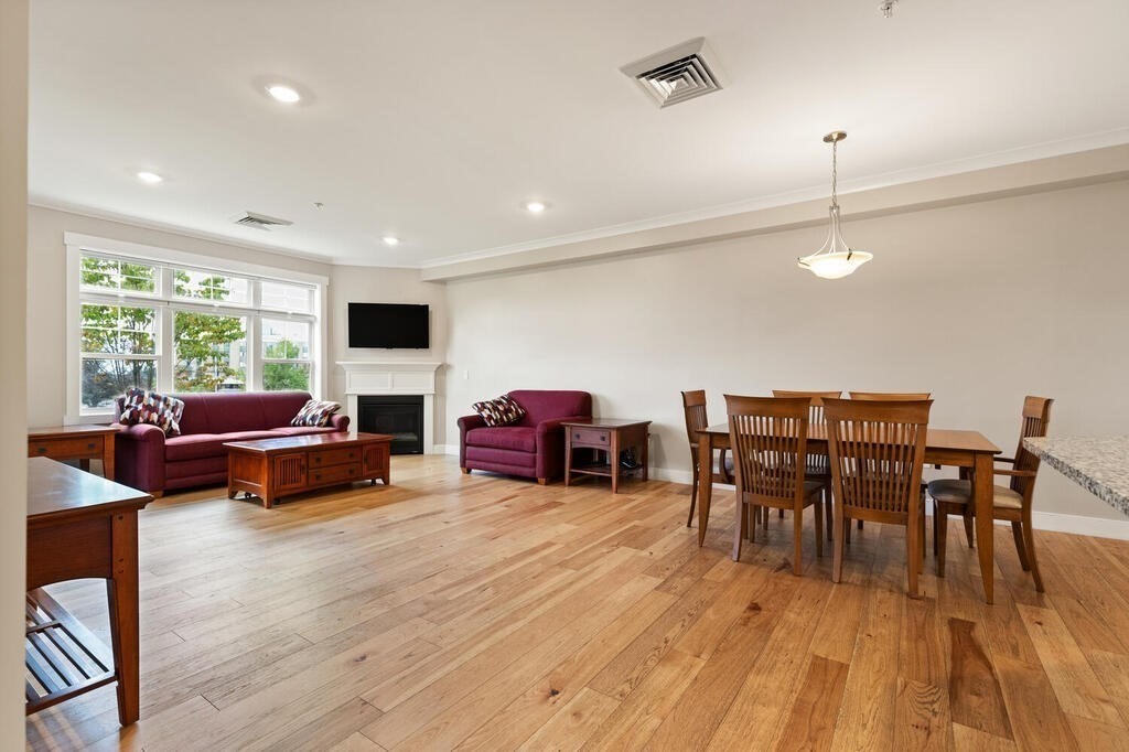 11 Executive Drive, Unit 118 Stoneham, MA 02180 - Photo 8 of 36 a living room with furniture fireplace and wooden floor