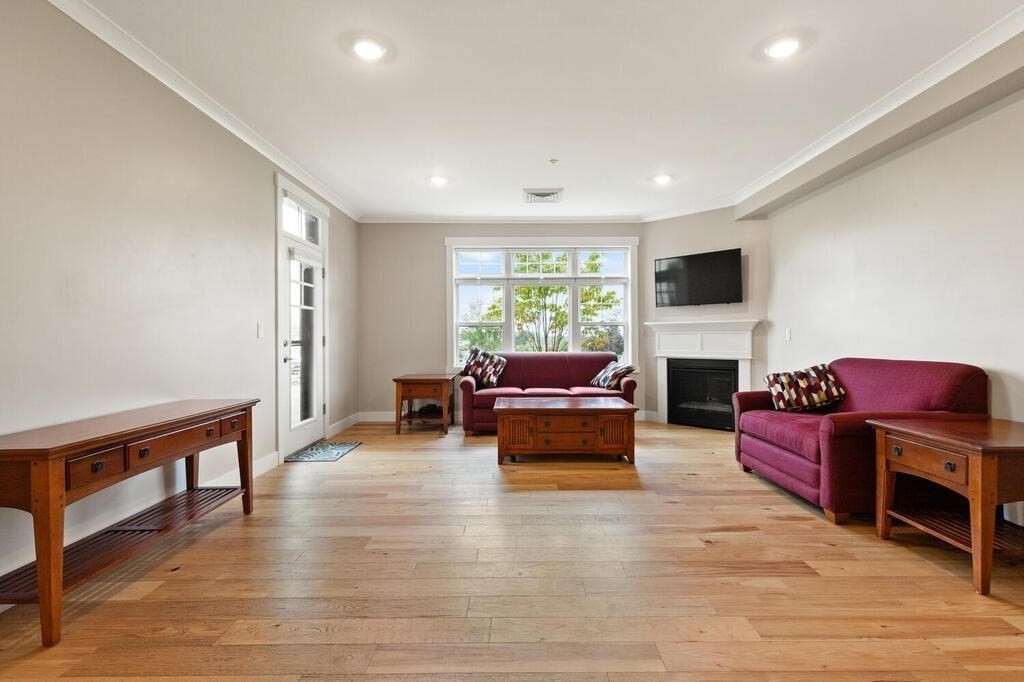 11 Executive Drive, Unit 118 Stoneham, MA 02180 - Photo 10 of 36 a living room with furniture fireplace and flat screen tv