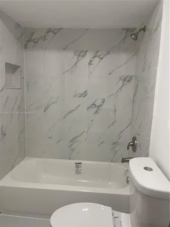 a bathroom with a toilet and a bathtub
