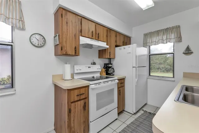 a kitchen with a stove a sink and a refrigerator