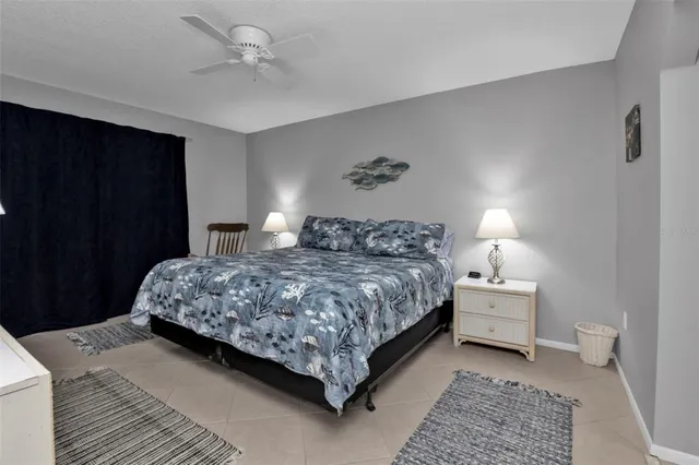 a bedroom with a bed and a lamp