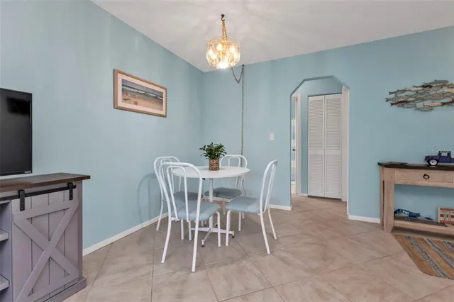 a dining room with furniture and chandelier