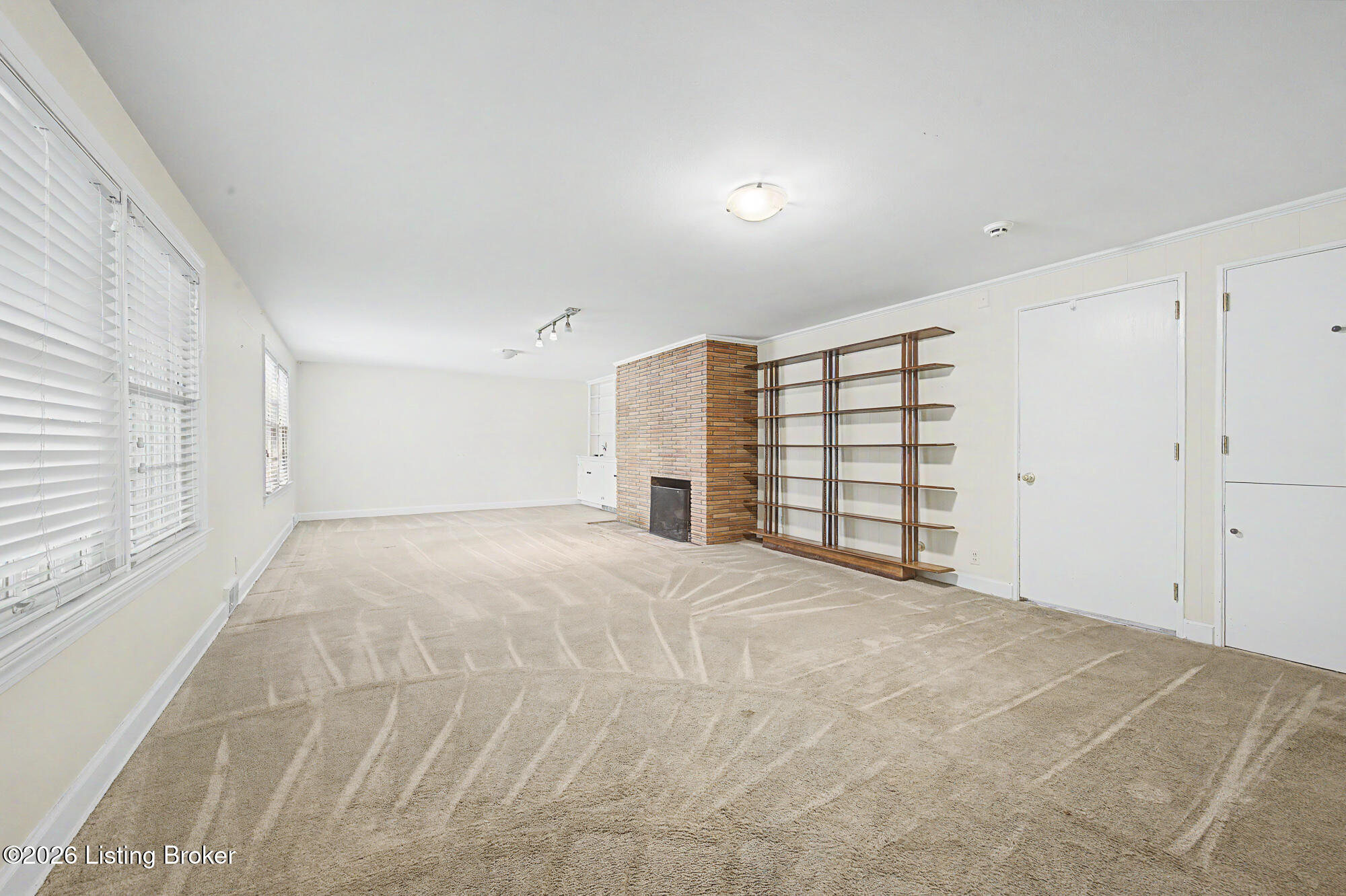 5402 Hempstead Road Louisville, KY 40207 - Photo 30 of 50 Lower level family room includes a wood burning fireplace, and built-in bookcases.
