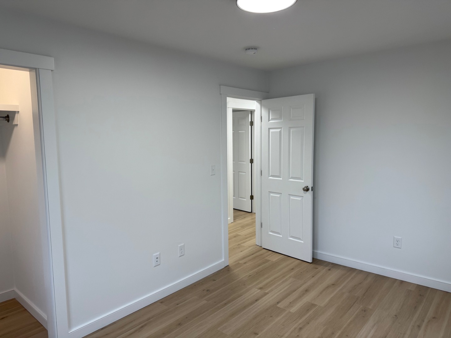 106 Old South Road, Unit A B Nantucket, MA 02554 - Photo 19 of 24 a view of an empty room and wooden floor