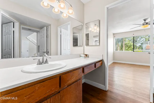 a bathroom with a sink double vanity granite and a large mirror