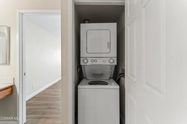 an empty room with closet and washing machine