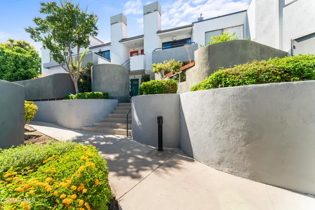 an aerial view of a house with a yard and garden