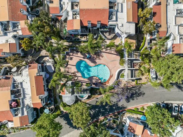 an aerial view of residential houses with outdoor space