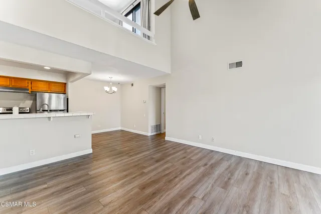 a view of a room with wooden floor and window