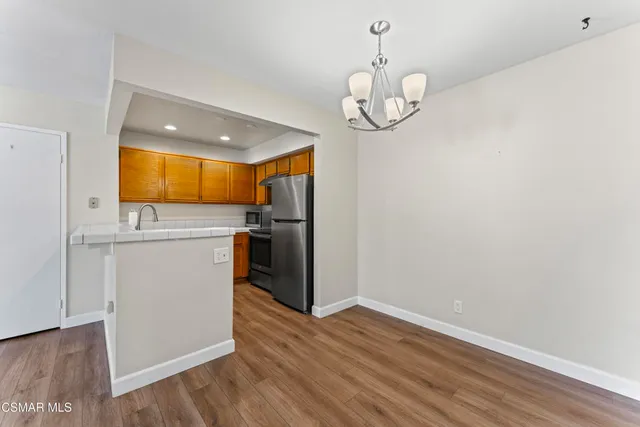 a view of a kitchen with a sink wooden floor and cabinets