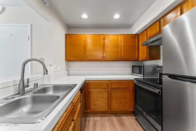 a kitchen with a sink cabinets and stainless steel appliances