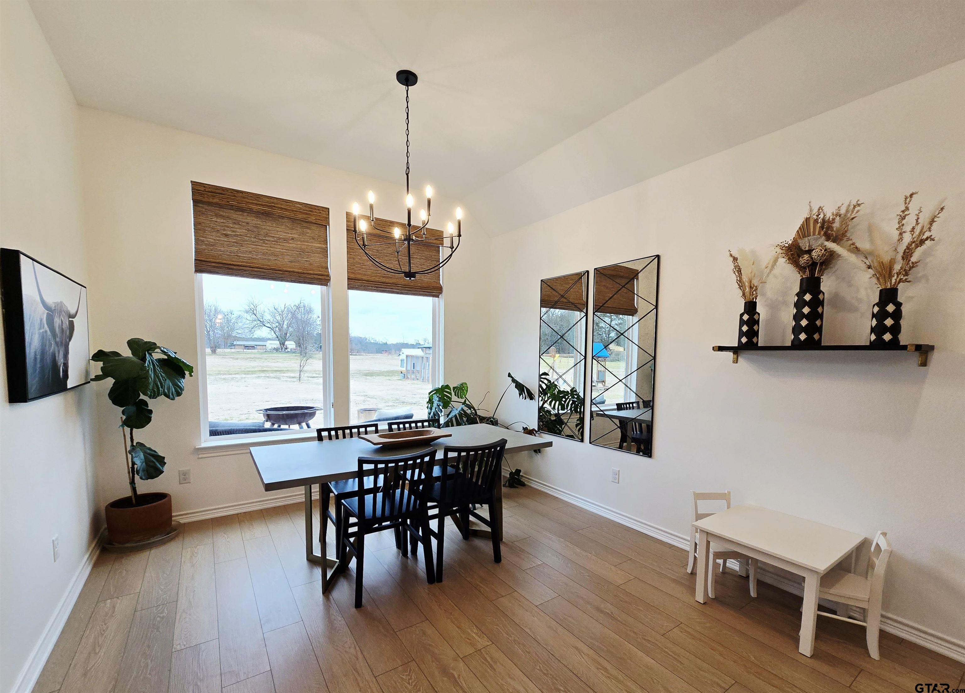 14932 Turtle Crk Rnch Road Flint, TX 75762 - Photo 19 of 33 a view of a dining room with furniture window and wooden floor