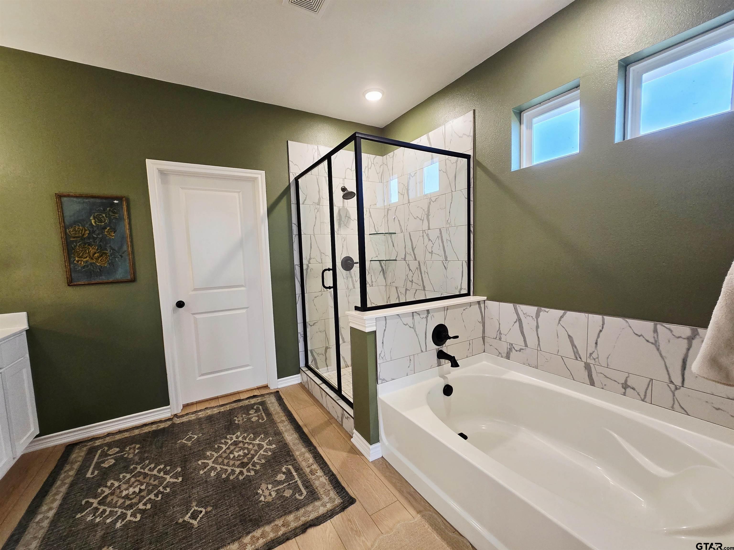 14932 Turtle Crk Rnch Road Flint, TX 75762 - Photo 29 of 33 a bathroom with a bathtub and a shower