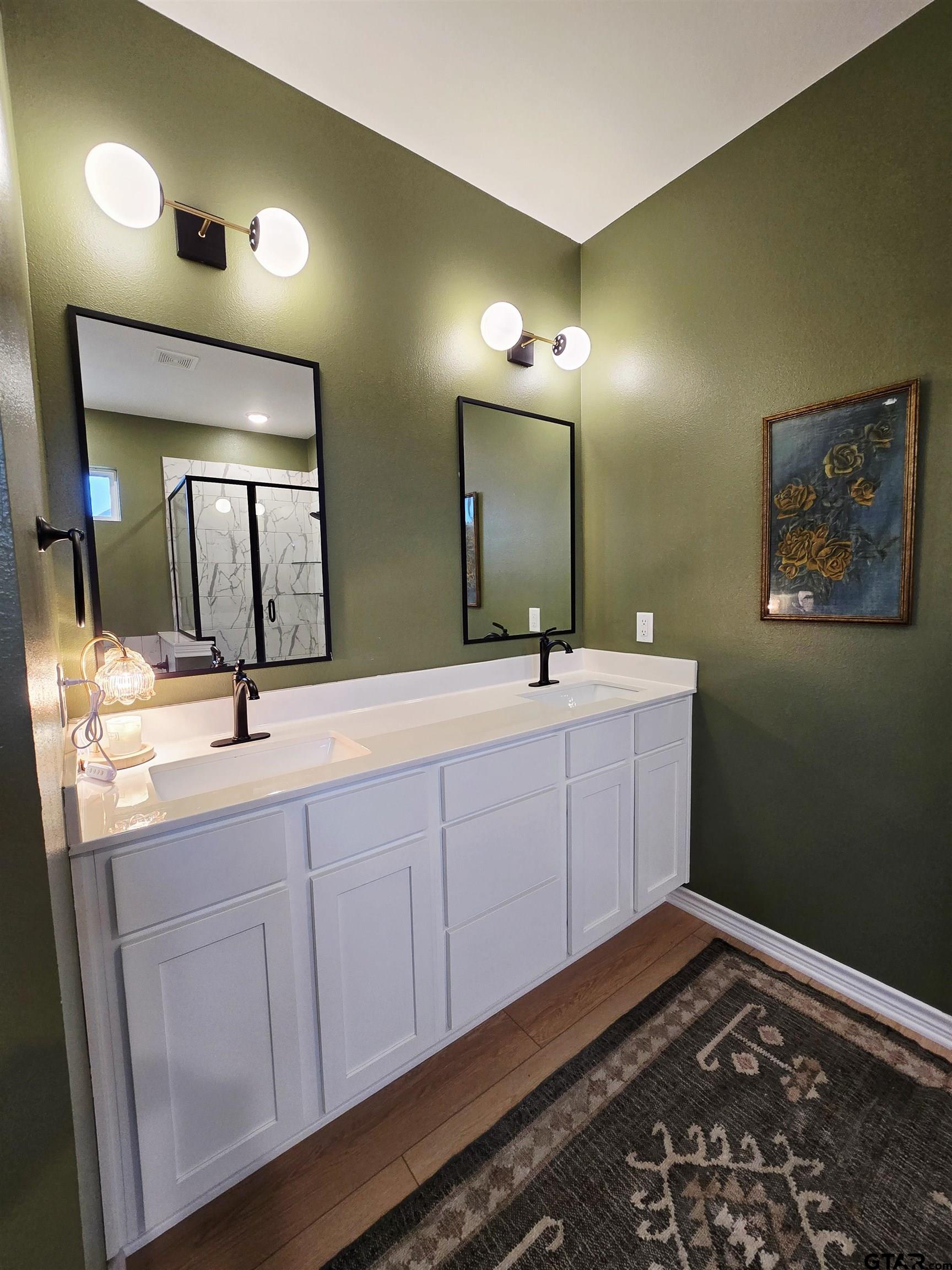 14932 Turtle Crk Rnch Road Flint, TX 75762 - Photo 32 of 33 a bathroom with a double vanity sink and a mirror