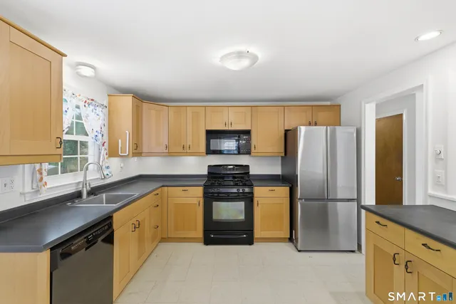 a kitchen with a refrigerator sink and stove