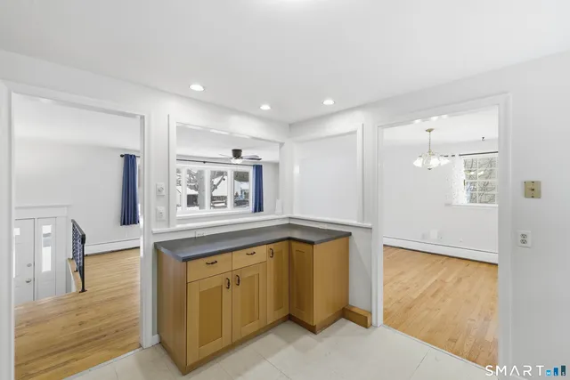 a spacious bathroom with a granite countertop sink a mirror and a bathtub