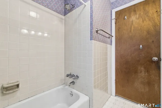 a bathroom with a bathtub and shower