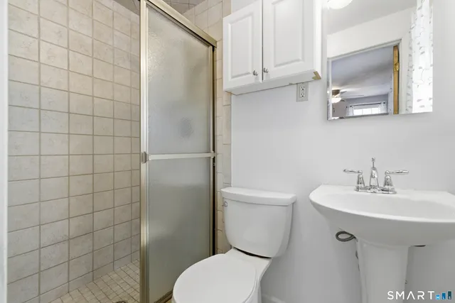 a white toilet sitting next to a bathroom sink