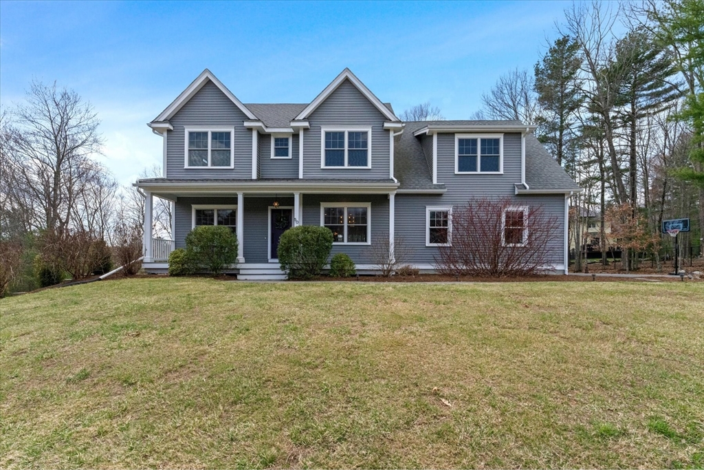 50 Quabbin Path Sutton, MA 01590 - Photo 1 of 42 a front view of a house with a garden