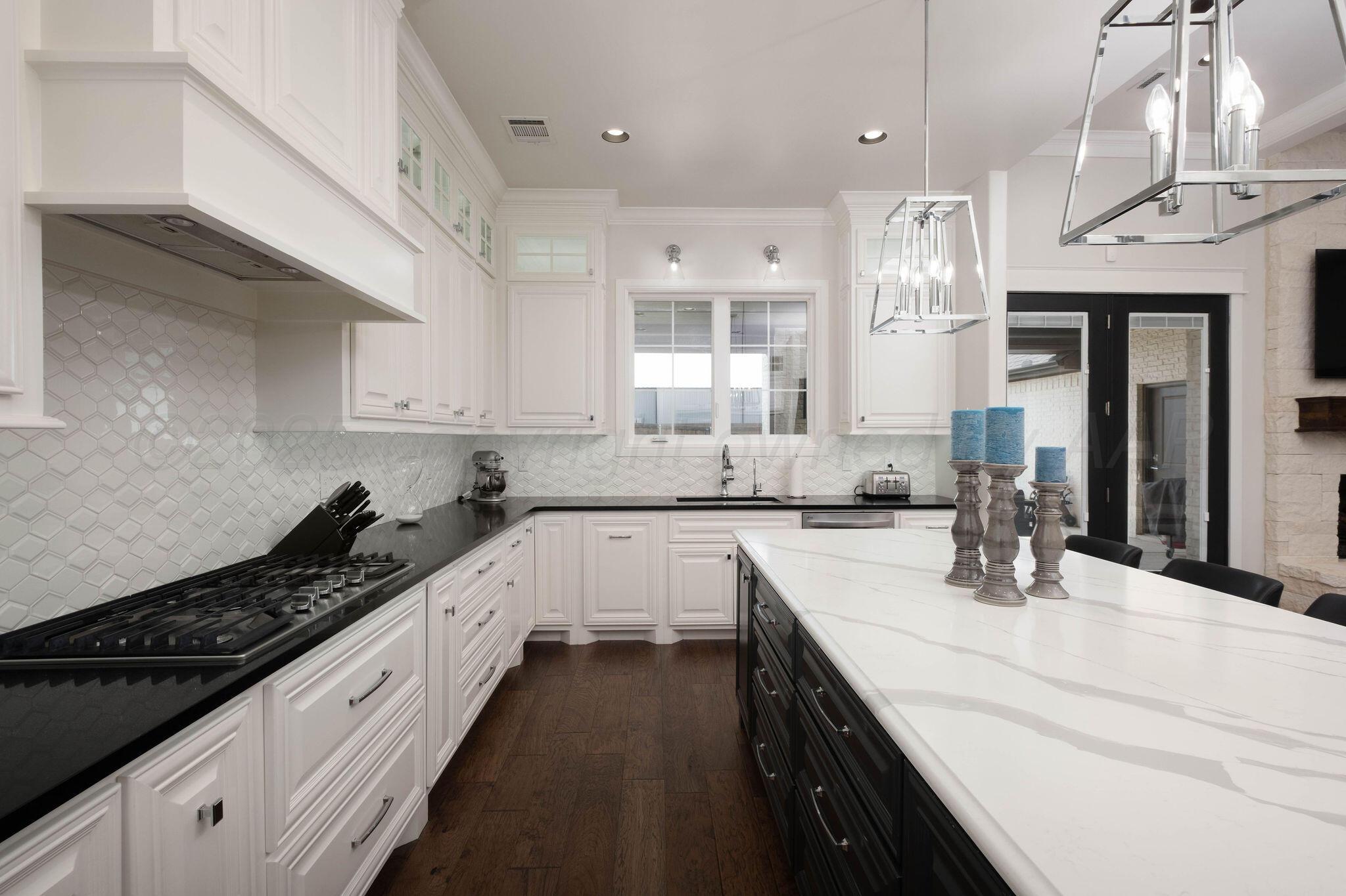 6103 Foley Square Street Amarillo, TX 79119 - Photo 17 of 52 a kitchen with a sink stove and cabinets