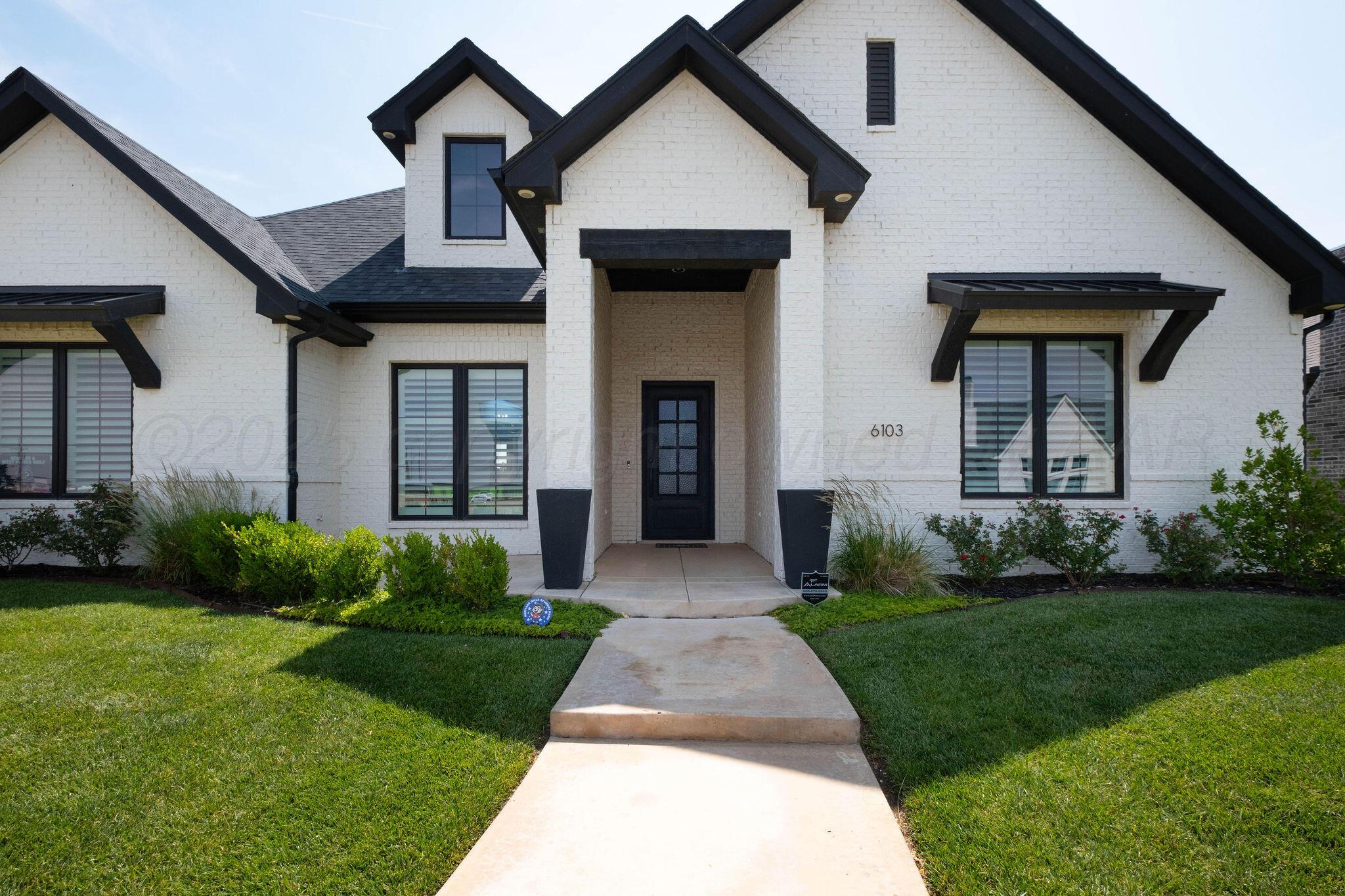 6103 Foley Square Street Amarillo, TX 79119 - Photo 2 of 52 a front view of a house with garden