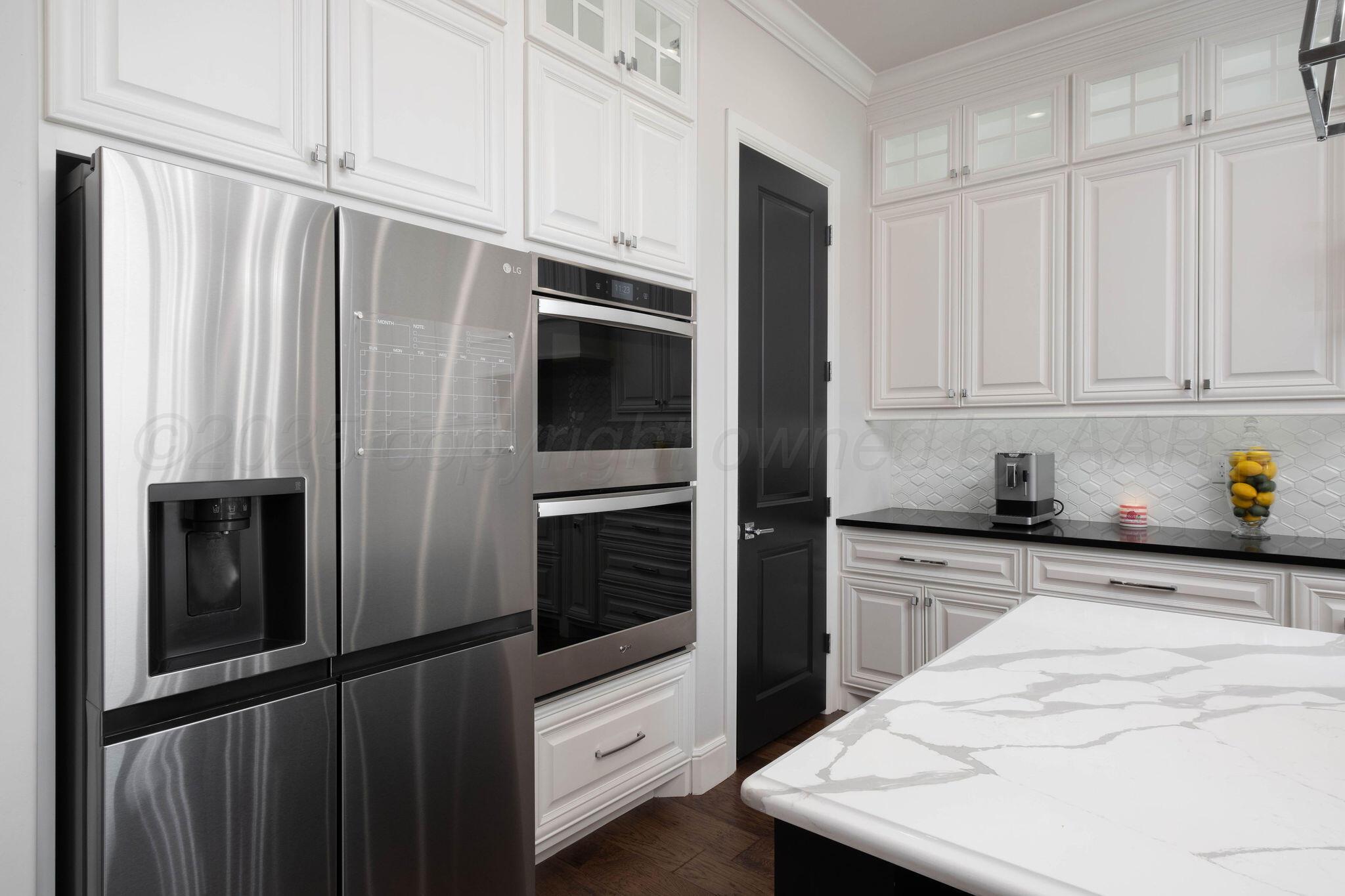6103 Foley Square Street Amarillo, TX 79119 - Photo 21 of 52 a kitchen with stainless steel appliances a refrigerator a stove and white cabinets