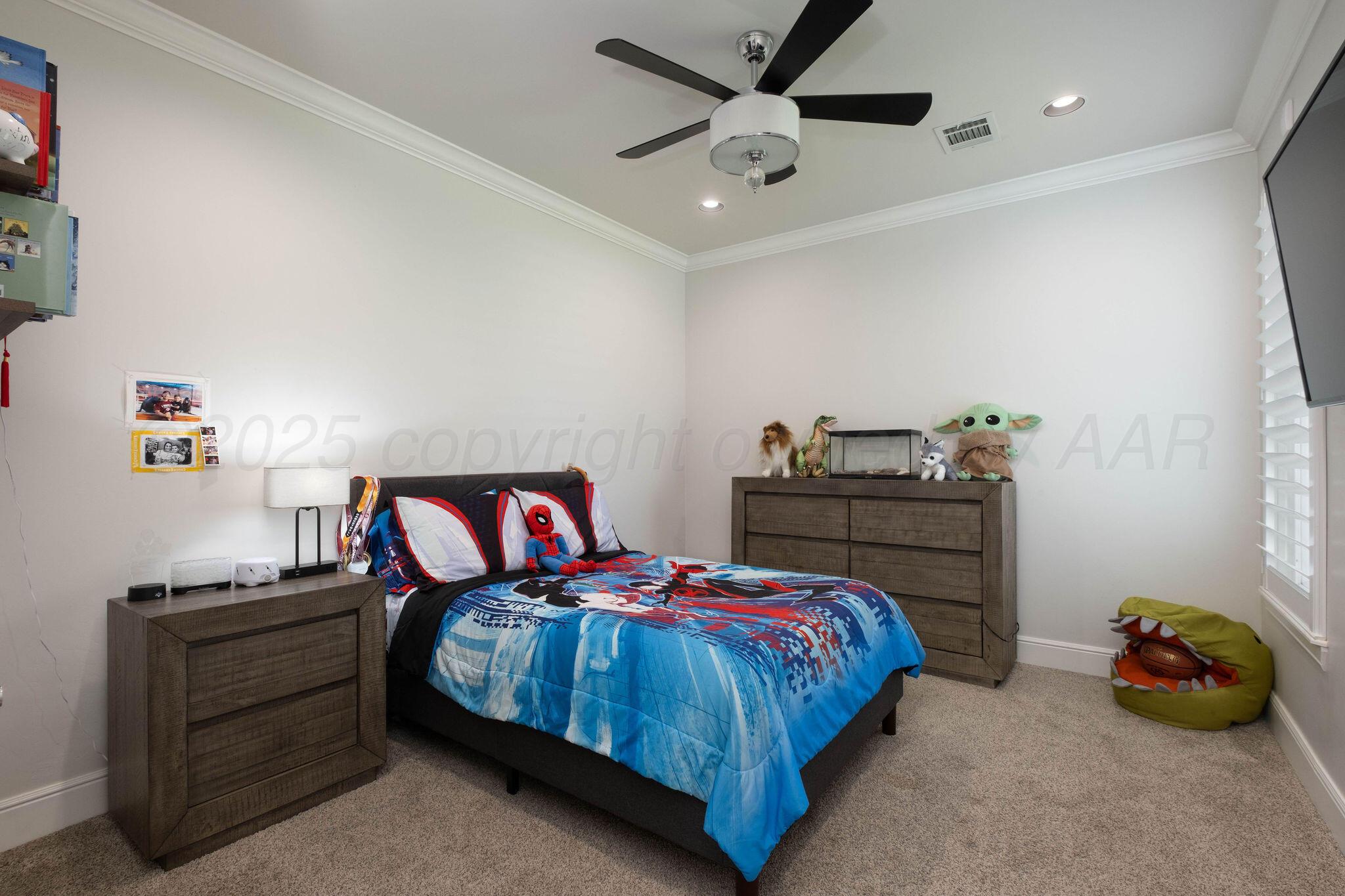 6103 Foley Square Street Amarillo, TX 79119 - Photo 34 of 52 a bedroom with a bed and a chandelier