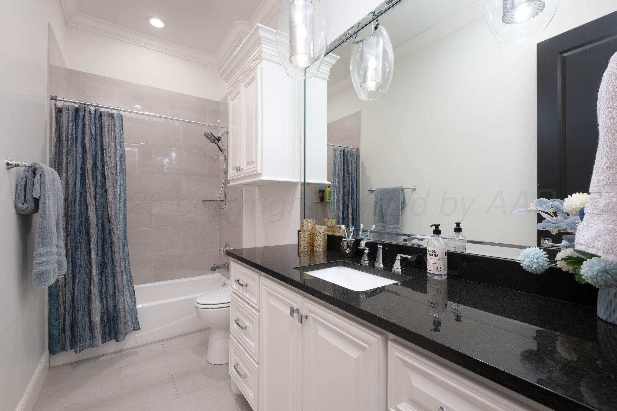 6103 Foley Square Street Amarillo, TX 79119 - Photo 36 of 52 a bathroom with a double vanity sink toilet and shower