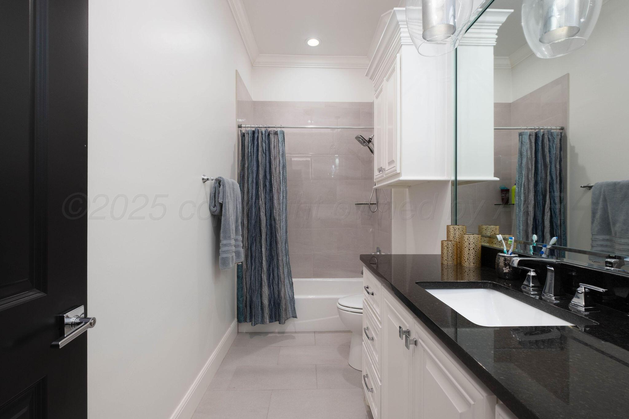 6103 Foley Square Street Amarillo, TX 79119 - Photo 37 of 52 a bathroom with a granite countertop sink and a mirror