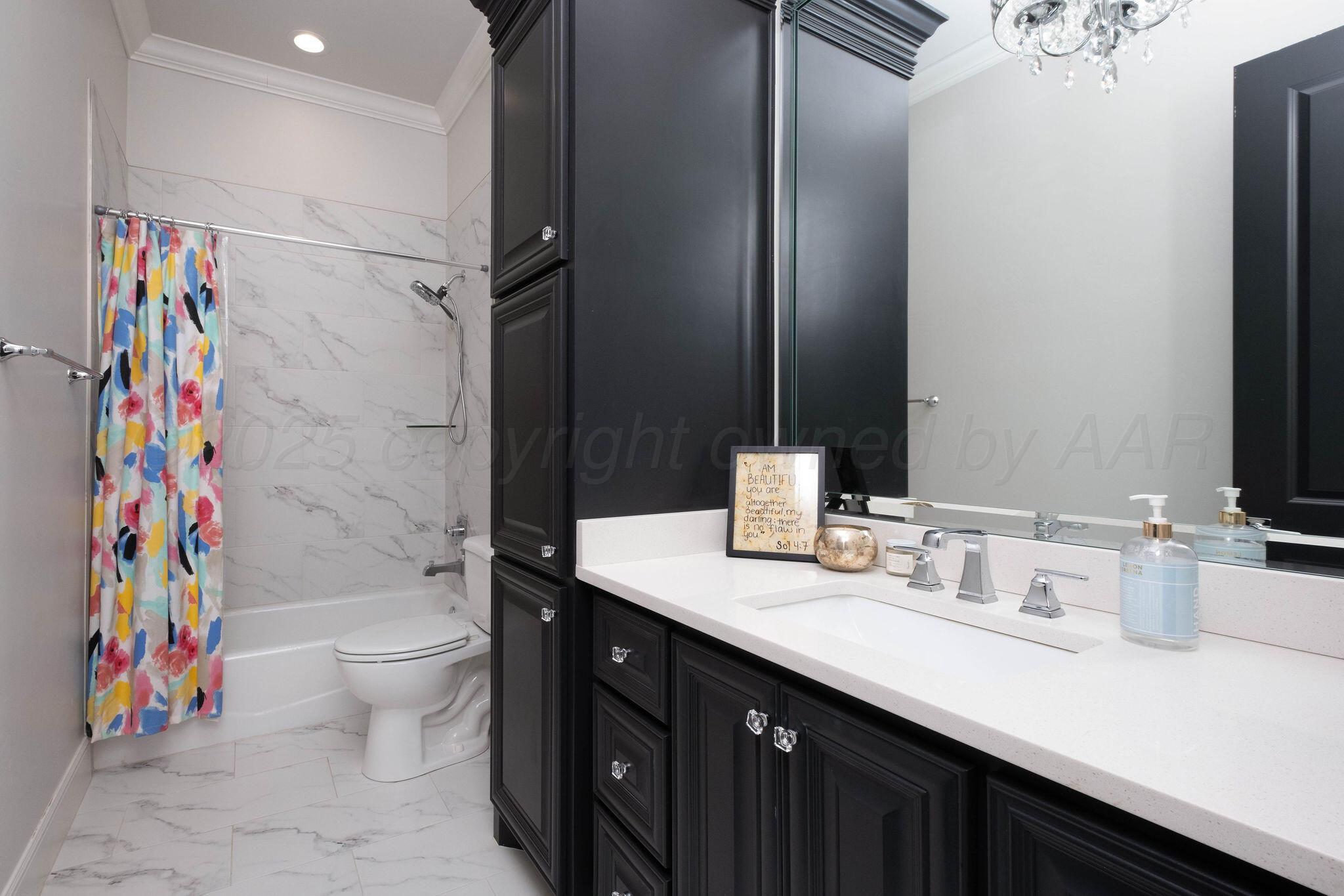 6103 Foley Square Street Amarillo, TX 79119 - Photo 43 of 52 a bathroom with a sink a toilet and shower