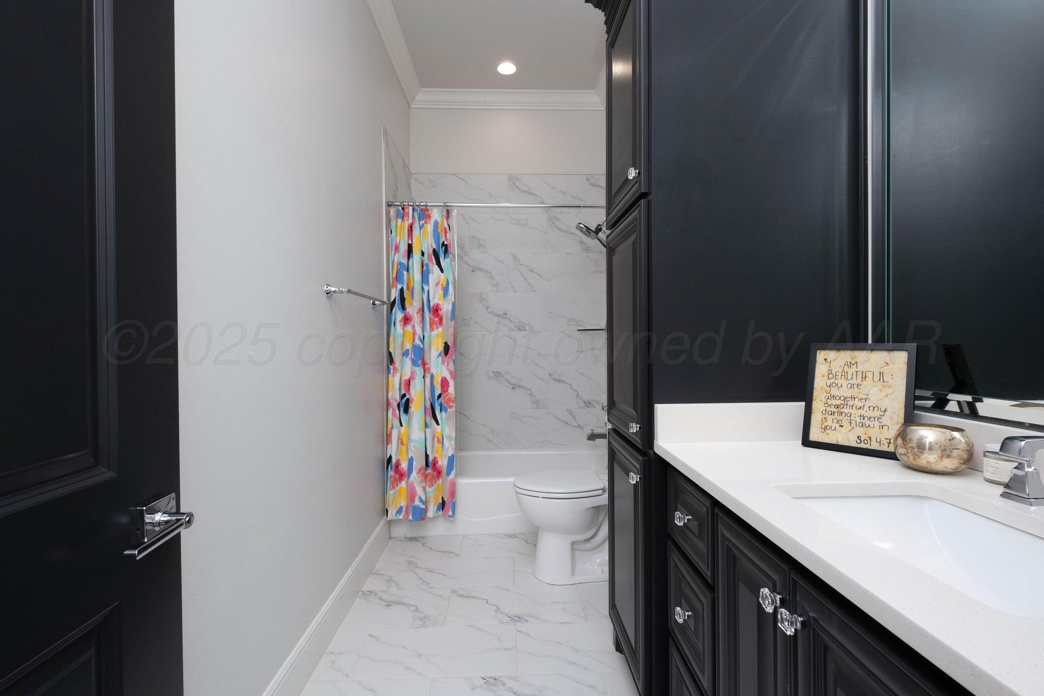 6103 Foley Square Street Amarillo, TX 79119 - Photo 44 of 52 a bathroom with a sink a toilet and shower