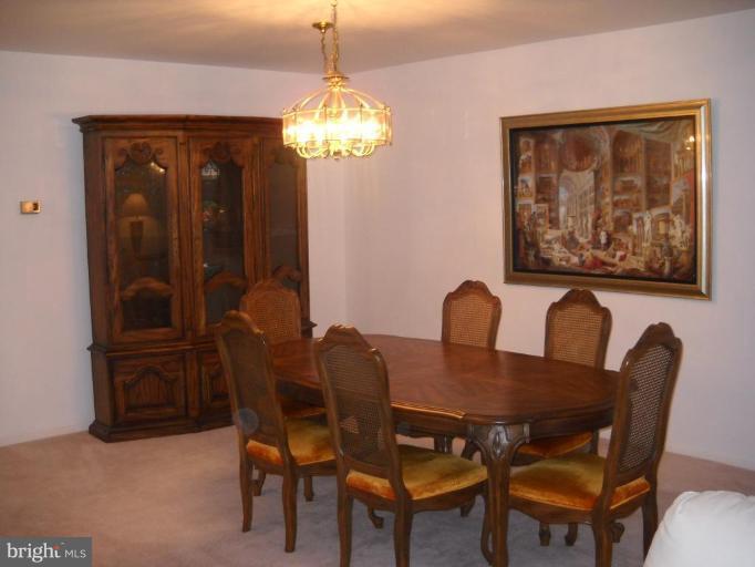 3922 Rolling Rd., Unit 3922 Pikesville, MD 21208 - Photo 3 of 6 a view of a dining room with furniture and chandelier