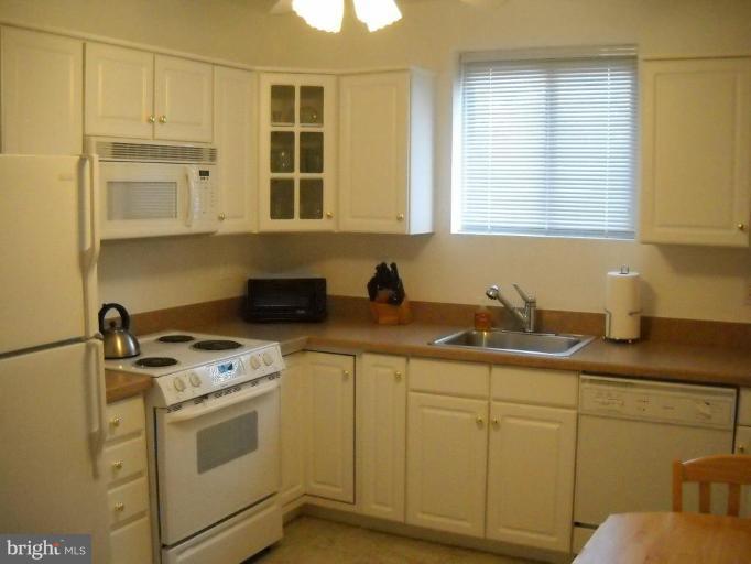 3922 Rolling Rd., Unit 3922 Pikesville, MD 21208 - Photo 4 of 6 a kitchen with white cabinets and white appliances