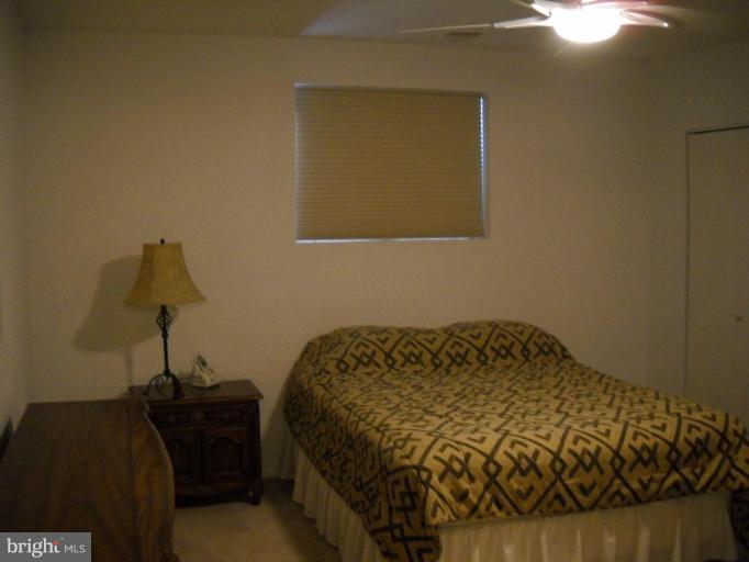 3922 Rolling Rd., Unit 3922 Pikesville, MD 21208 - Photo 5 of 6 a bedroom with a bed and a dresser