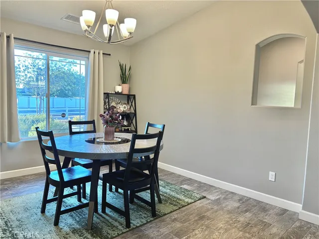 a view of a dining room with furniture wooden floor and chandelier