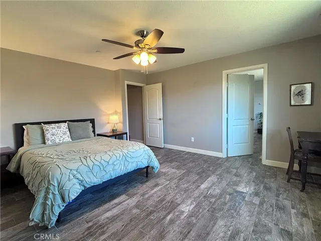 a spacious bedroom with a bed and a chandelier