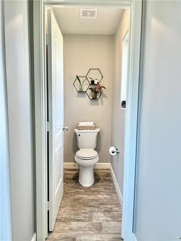 a bathroom with a toilet and a view of bathroom