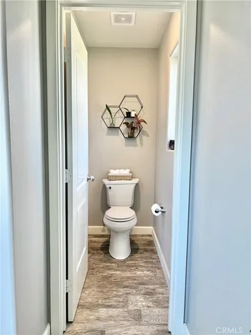a bathroom with a toilet and a view of bathroom