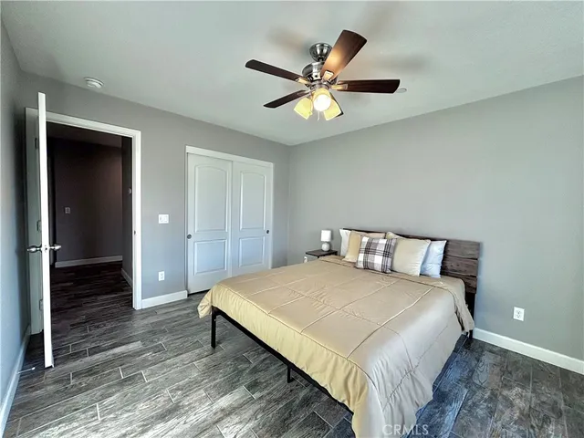 a bedroom with a large bed and a chandelier