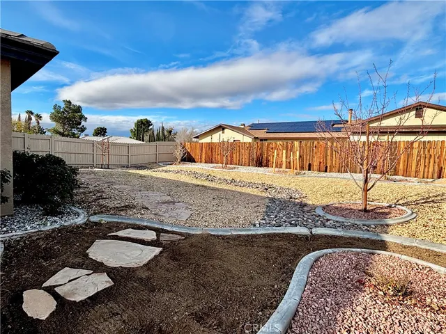 a view of a backyard with plants and a patio