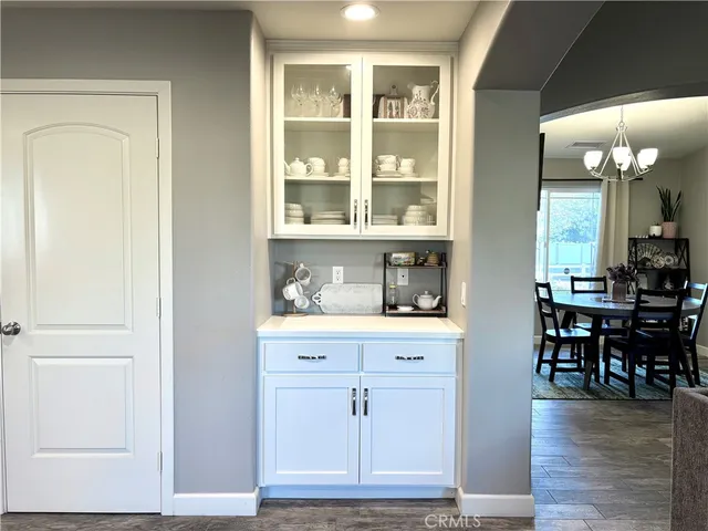 an entryway with wooden floor and cabinets