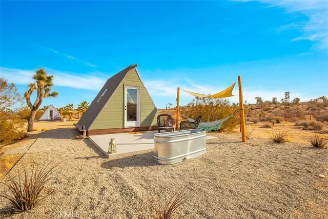 a bedroom with a bed and painting on the wall