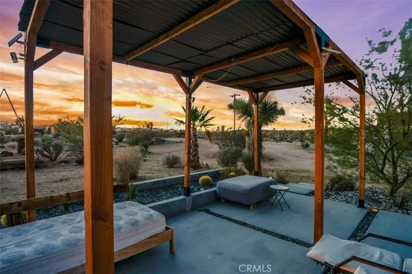 a view of a chair and table in the patio