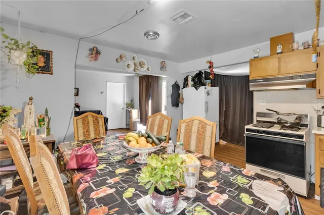 a kitchen with stainless steel appliances kitchen island granite countertop a table and chairs in it
